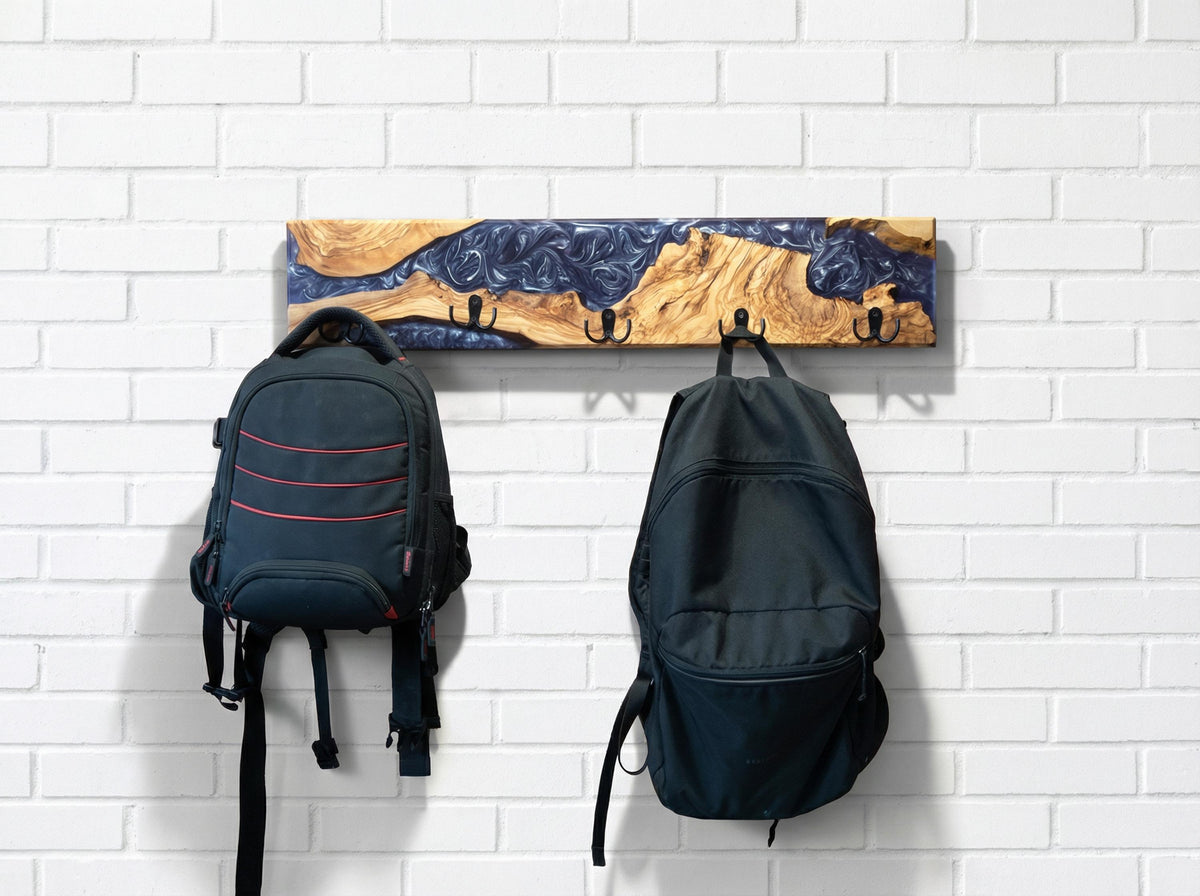 Perchero de pared en madera de olivo con resina violeta y dos mochilas colgadas