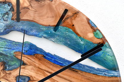 Reloj de pared en madera de olivo con resina epoxy azul y vetas naturales