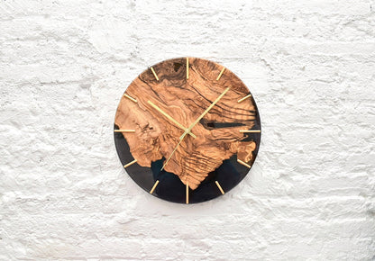 Reloj de pared de madera de olivo con resina negra, decoración natural elegante.